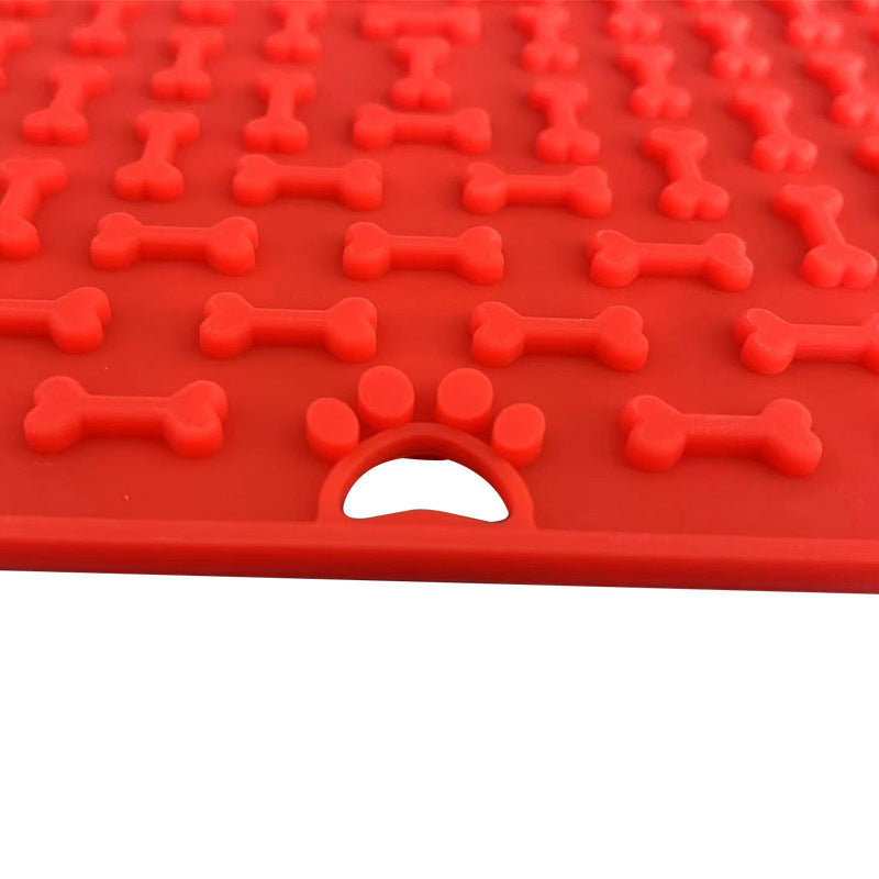 Silicone lick mat in red, close-up of the bone texture