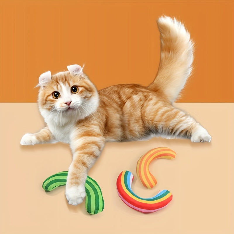 Cat playing with striped catnip pillows