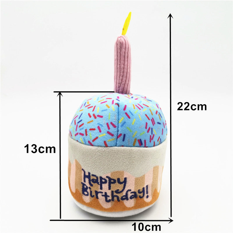 Mini birthday-cake plush dog toy with pastel blue frosting and pink candle, 10 x 22 cm